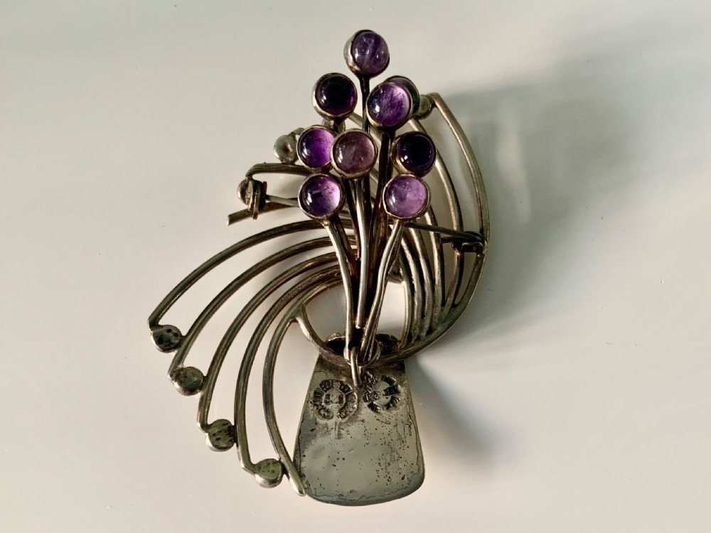 A Mexican sterling silver brooch designed with sweeping curved wires and hanging purple amethyst cabochons. View IV
