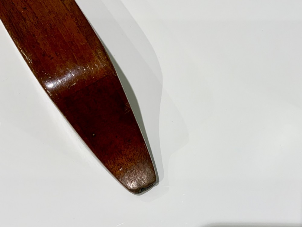 An elongated, rectangular wooden pitch pipe crafted from dark mahogany with a tapered mouthpiece at one end and a sound aperture. View VI
