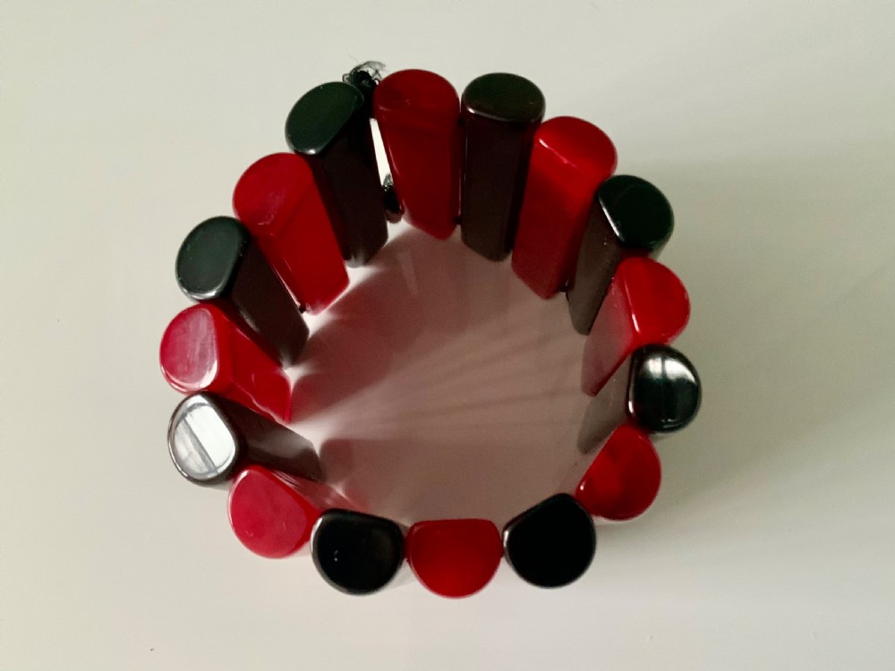 An early twentieth-century Art Deco stretch cuff bracelet featuring alternating vertical smooth red and black Bakelite segments. View II