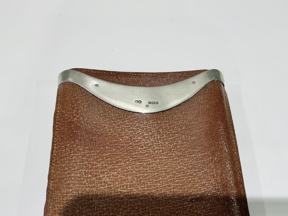 A stitched chestnut brown leather cigar case featuring a curved silver rim mount with engraved initials. View III