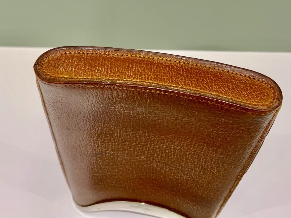 A stitched chestnut brown leather cigar case featuring a curved silver rim mount with engraved initials. View V