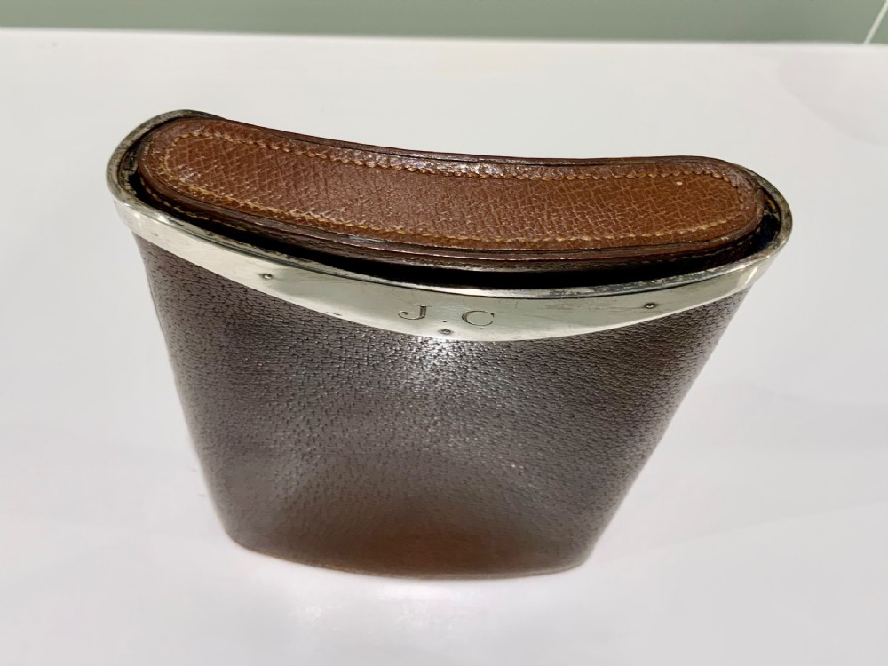 A stitched chestnut brown leather cigar case featuring a curved silver rim mount with engraved initials. View VI