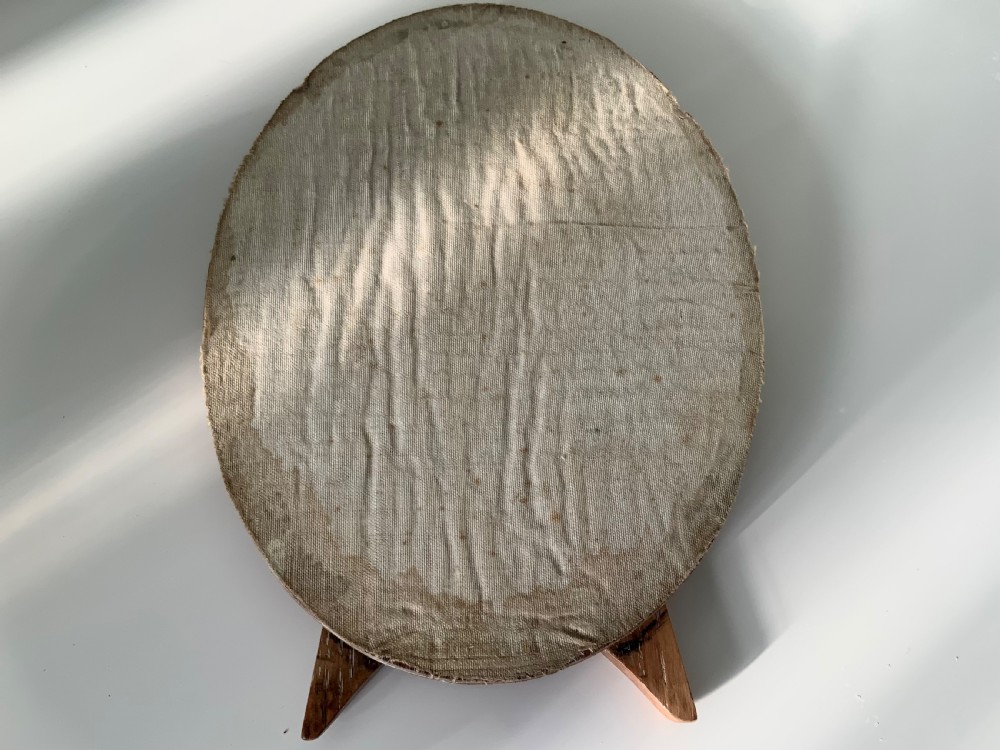 An early 20th-century oval silver photograph frame featuring an engine-turned textured border. View V