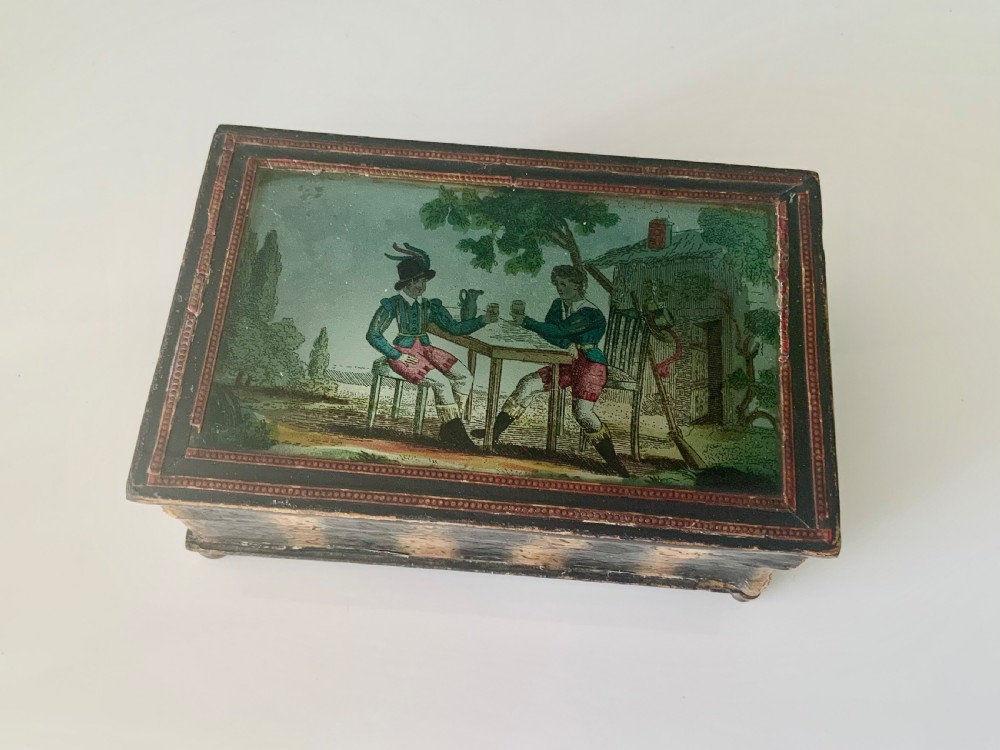 An early 19th-century rectangular French dragee box featuring a hand-coloured printed tavern scene set beneath a glass lid.
