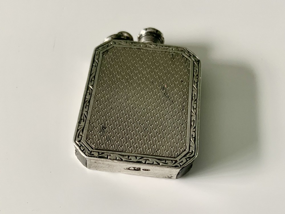 A rectangular silver striker tinder box watch fob featuring engine-turned geometric engraving and a removable threaded wand with a wick end. View VI