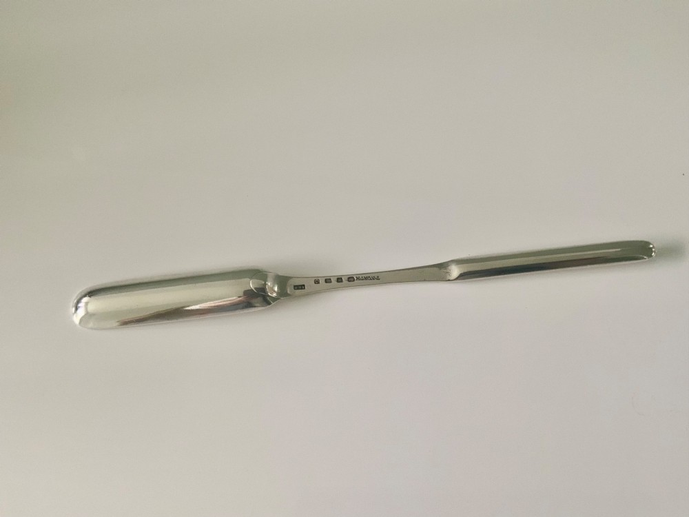 An antique double-ended sterling silver marrow scoop featuring two elongated trough-shaped bowls of differing widths connected by a narrow central shank. View II