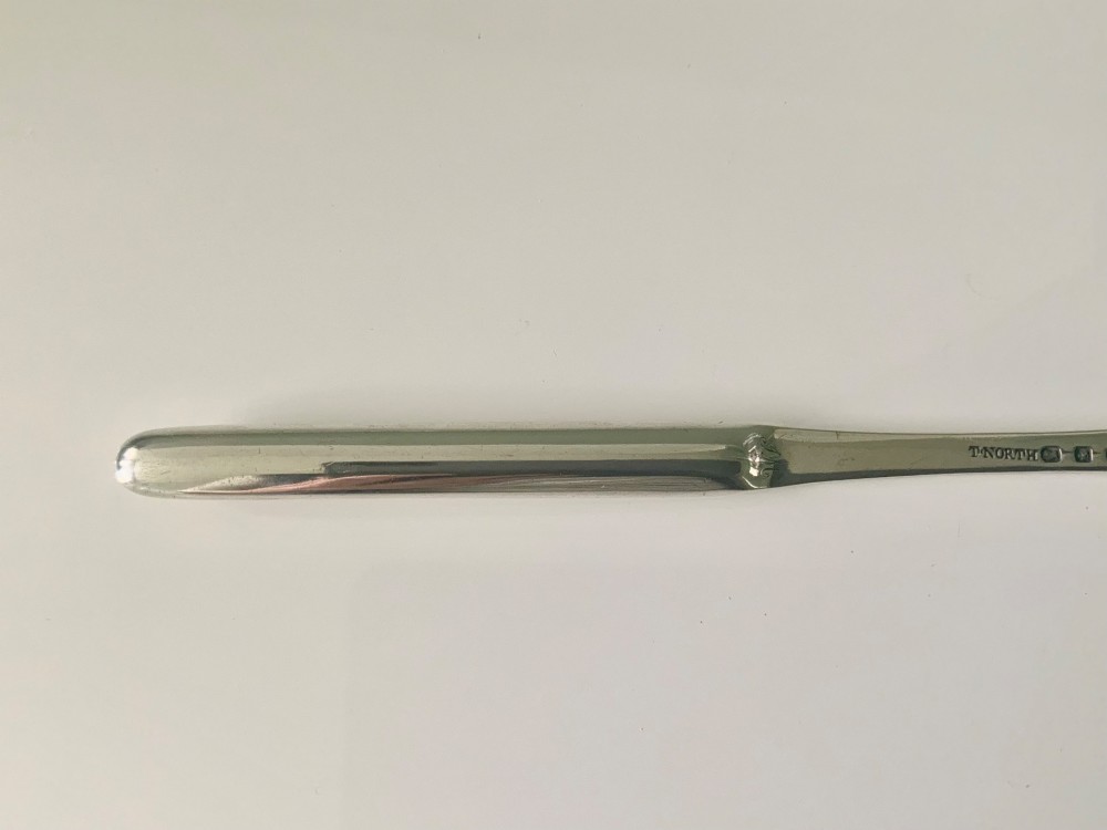 An antique double-ended sterling silver marrow scoop featuring two elongated trough-shaped bowls of differing widths connected by a narrow central shank. View VII