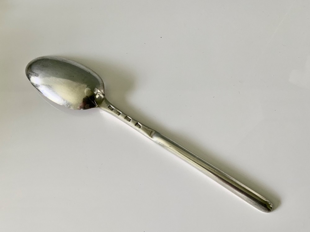 A sterling silver Georgian marrow spoon featuring an oval spoon bowl at one end transitioning into a narrow grooved scoop along the stem. View II