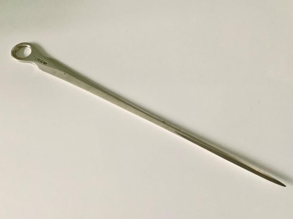 A tapered Georgian sterling silver meat skewer featuring a round ring top terminal and stamped hallmarks.