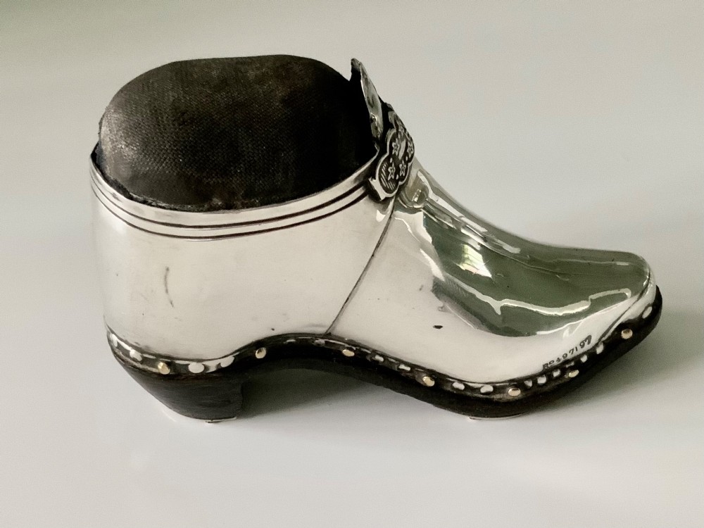 An antique sterling silver pin cushion crafted in the shape of a clog shoe with a dark velvet pad and visible hallmarks. View III