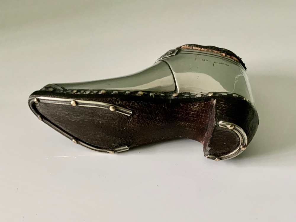 An antique sterling silver pin cushion crafted in the shape of a clog shoe with a dark velvet pad and visible hallmarks. View V