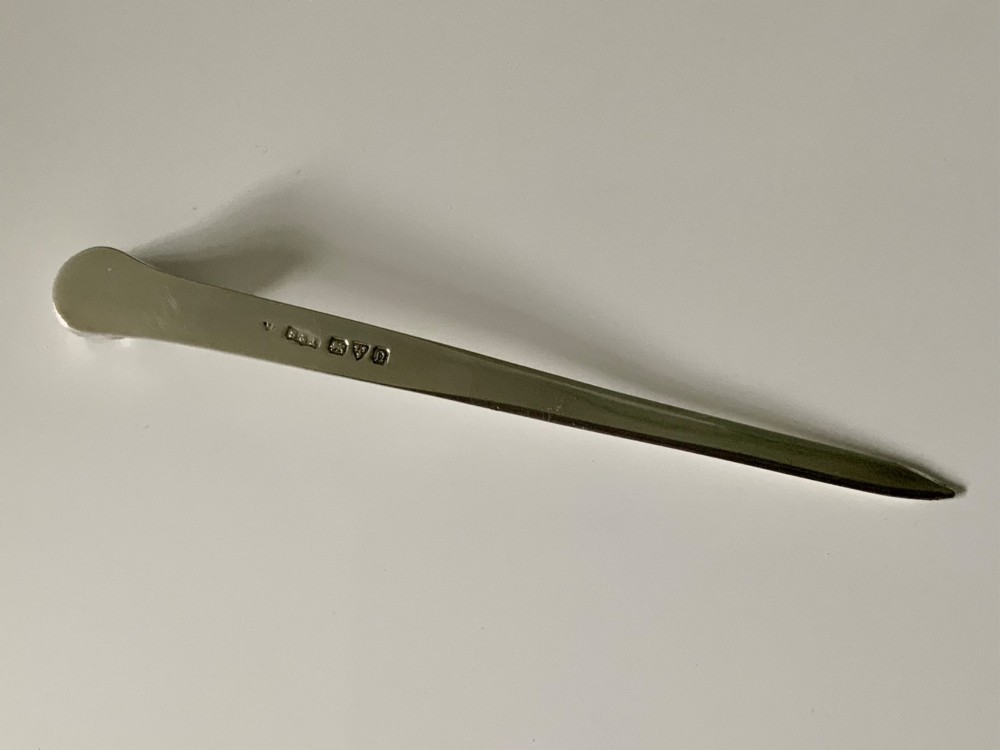 An antique sterling silver letter opener featuring a flat tapered blade and a detailed cast fox head terminal. View IV