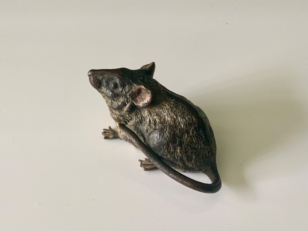 An antique Austrian cold-painted bronze figurine of a mouse shown sitting with its tail wrapped around its body. View II