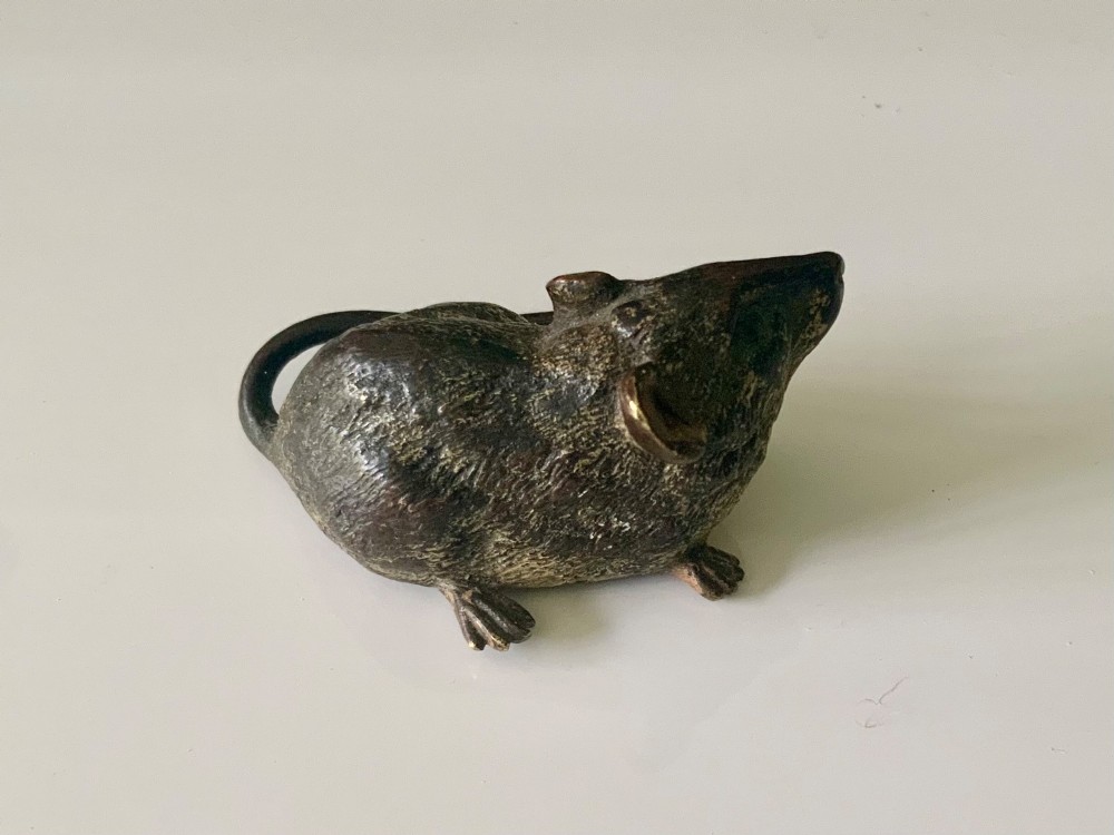 An antique Austrian cold-painted bronze figurine of a mouse shown sitting with its tail wrapped around its body. View III