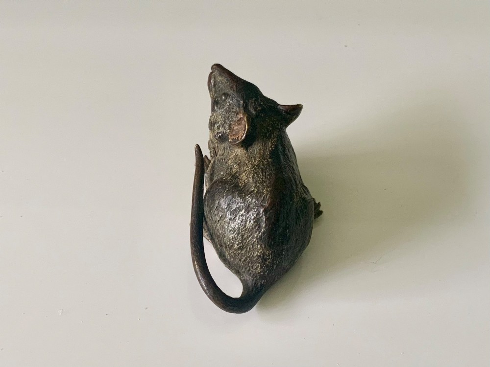 An antique Austrian cold-painted bronze figurine of a mouse shown sitting with its tail wrapped around its body. View IV