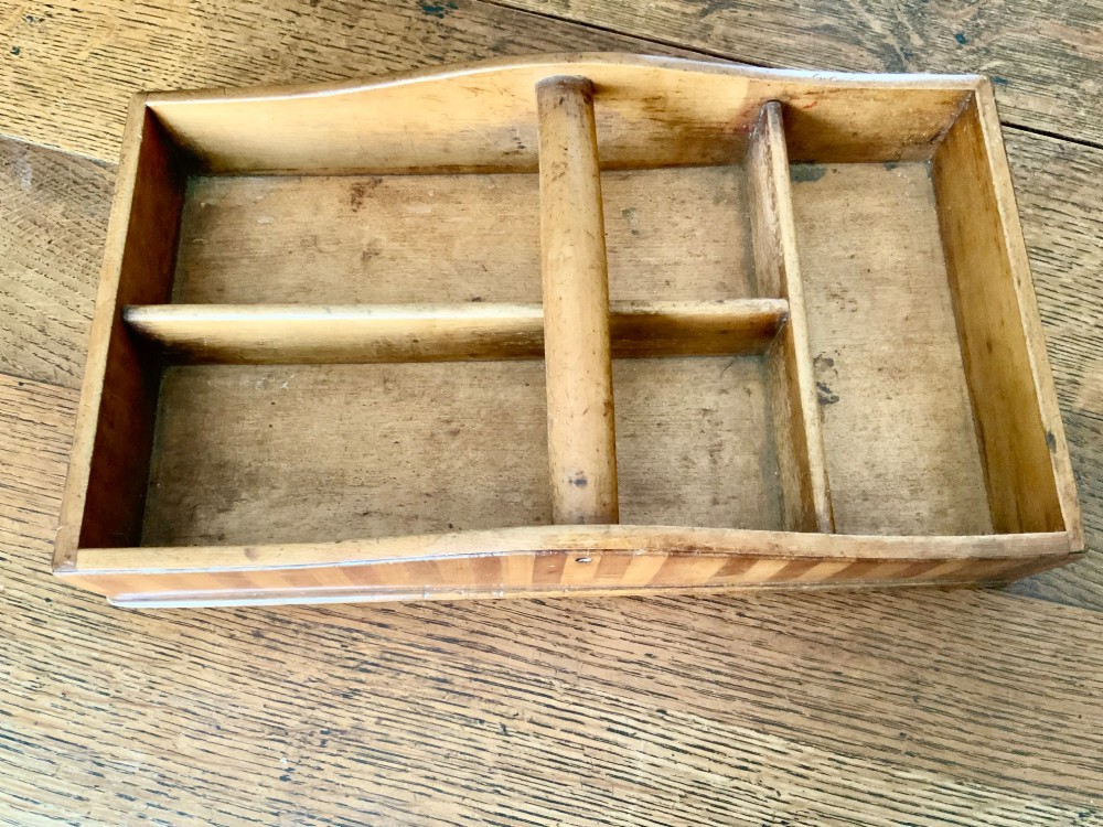 A nineteenth-century Scottish wooden cutlery tray with divided internal compartments, a turned cylindrical handle, and striped timber inlay along the exterior. View II