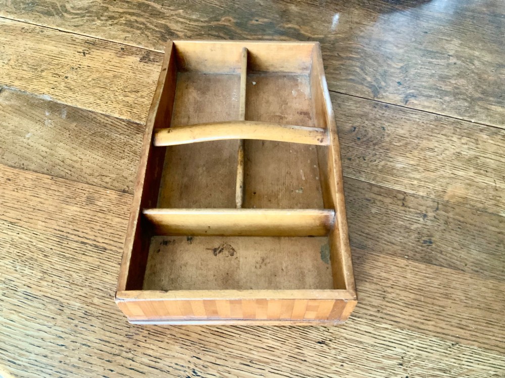 A nineteenth-century Scottish wooden cutlery tray with divided internal compartments, a turned cylindrical handle, and striped timber inlay along the exterior. View VI