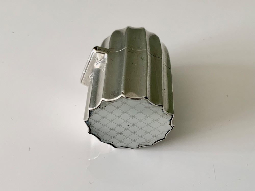 A small fluted sterling silver vinaigrette box featuring official hallmarks stamped onto its curved top section. View III