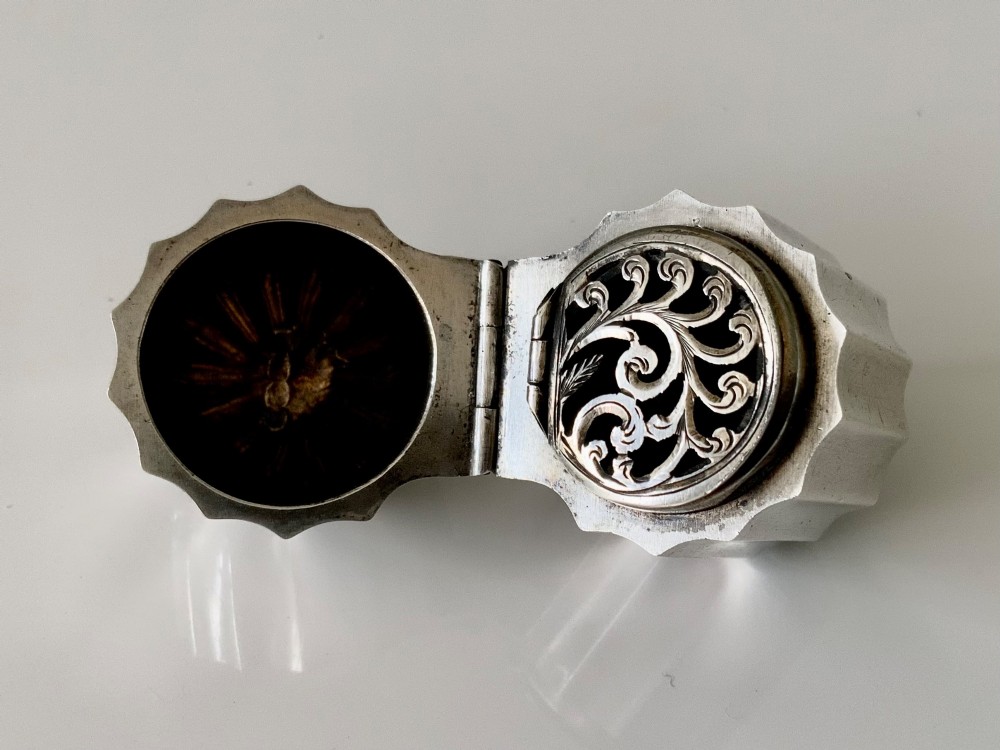 A small fluted sterling silver vinaigrette box featuring official hallmarks stamped onto its curved top section. View V