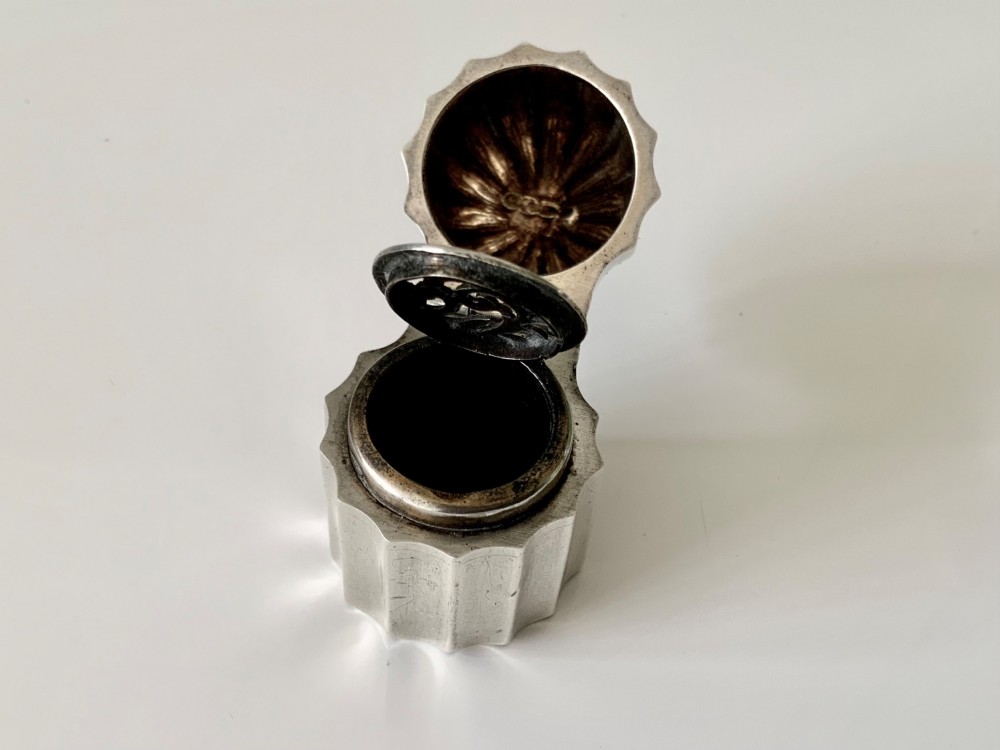 A small fluted sterling silver vinaigrette box featuring official hallmarks stamped onto its curved top section. View VII