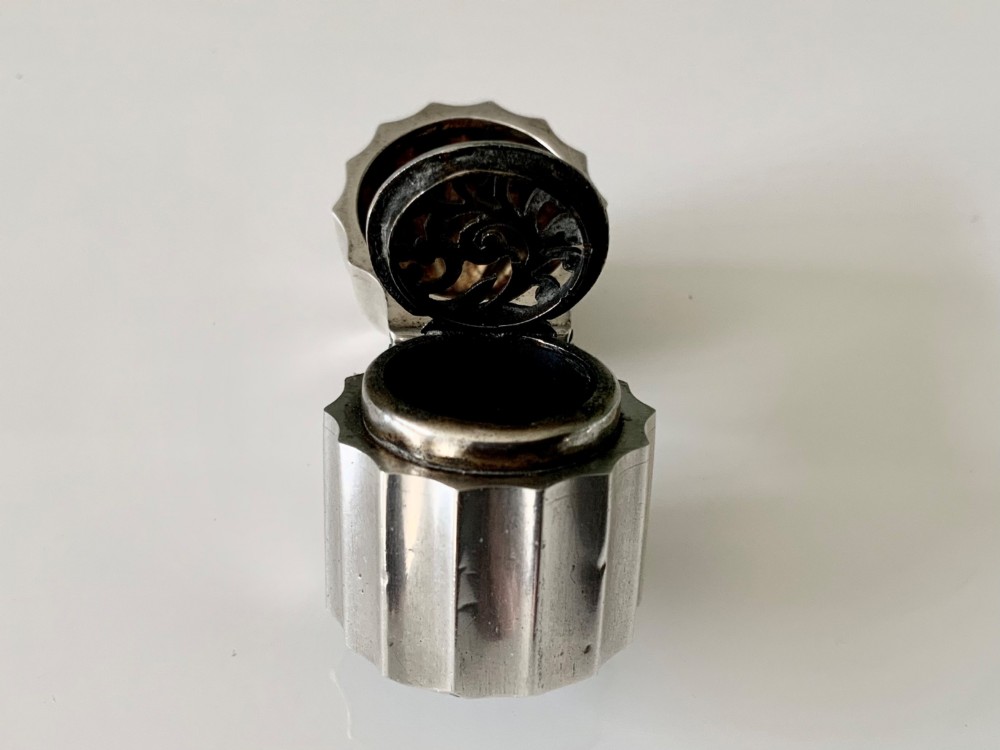 A small fluted sterling silver vinaigrette box featuring official hallmarks stamped onto its curved top section. View VIII
