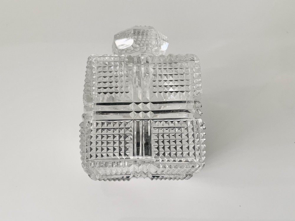 A square geometric cut glass travelling inkwell with a hallmarked sterling silver hinged lockdown mechanism attached alongside. View VII