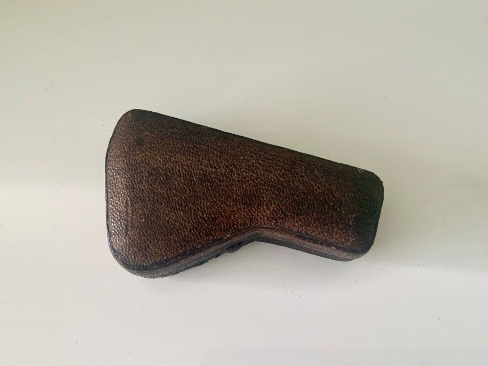 A nineteenth-century engraved brass pocket spectroscope resting inside an open fitted black leather case lined with bright blue velvet. View III