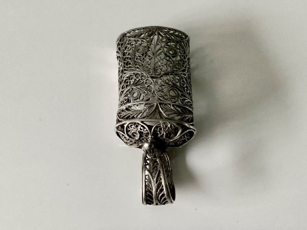 An antique Georgian silver filigree tea caddy spoon featuring intricate openwork scroll patterns and an engraved monogram cartouche on the loop handle. View III