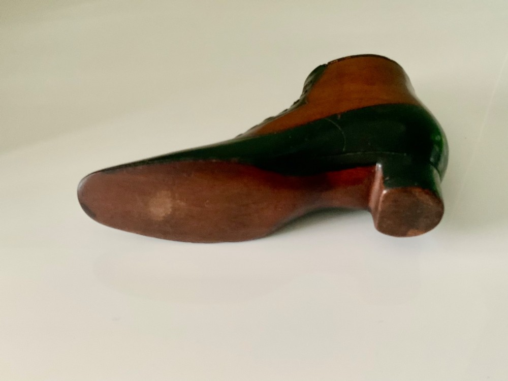 A carved wooden snuff box formed in the shape of a Victorian laced boot with polished black and natural timber finishes. View III