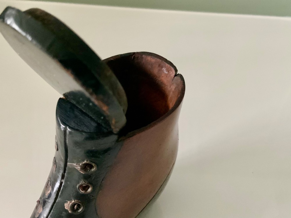 A carved wooden snuff box formed in the shape of a Victorian laced boot with polished black and natural timber finishes. View VI
