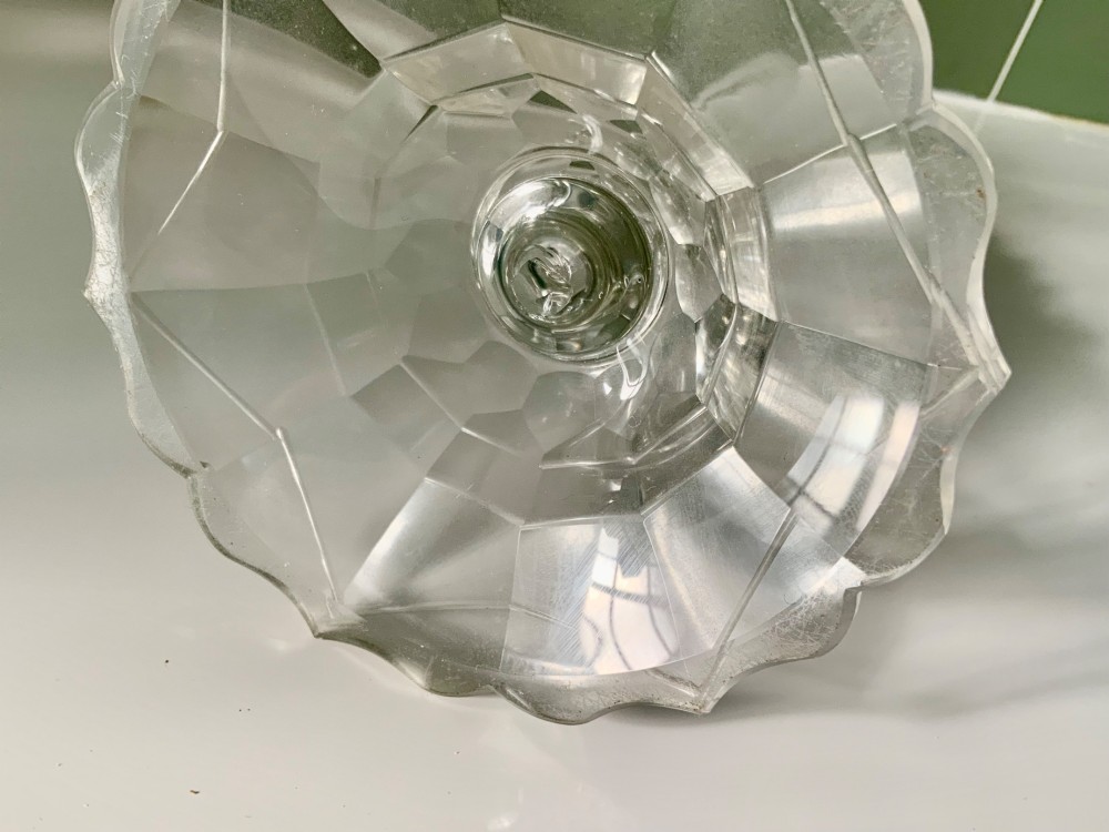 A Georgian clear glass taper stick featuring a faceted knopped stem and a scalloped, facet-cut domed base. View VI