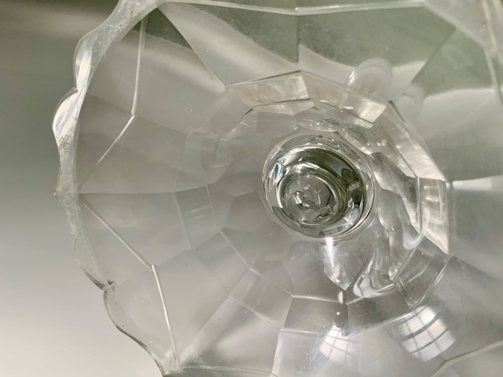 A Georgian clear glass taper stick featuring a faceted knopped stem and a scalloped, facet-cut domed base. View VII