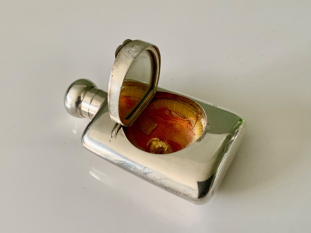 A hallmarked sterling silver combination scent bottle and powder compact with a hinged lid revealing an inner well alongside a small fabric powder puff. View VII