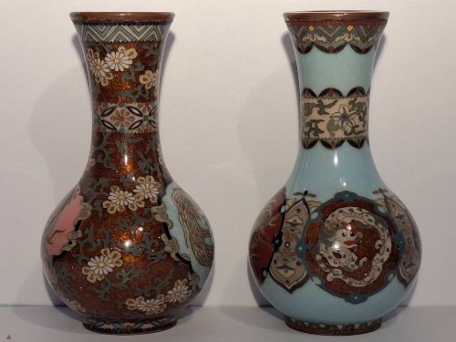 fig 1. A pair of Japanese Meiji period cloisonne enamel miniature vases featuring detailed dragon and phoenix medallions on brown and light blue grounds.