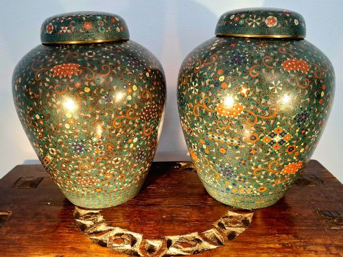 fig 2. A pair of rounded Japanese cloisonne enamel ginger jars decorated with dense green foliage scrollwork and colourful floral motifs with domed lids.