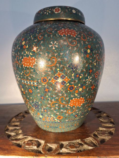 fig 3. A pair of rounded Japanese cloisonne enamel ginger jars decorated with dense green foliage scrollwork and colourful floral motifs with domed lids.
