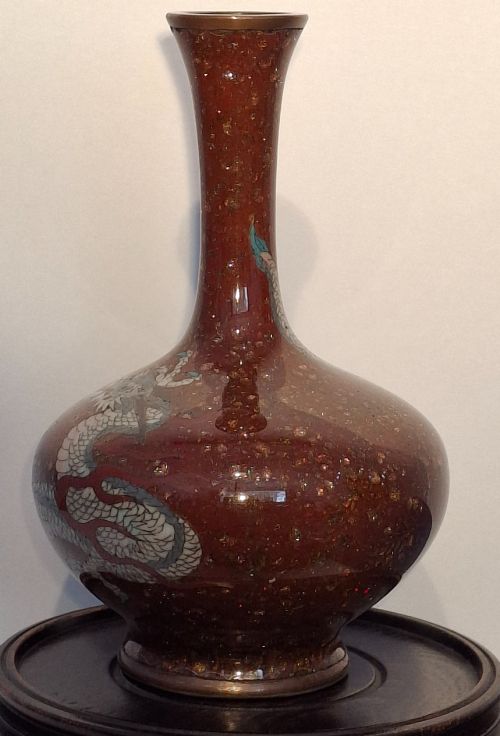 fig 1. A miniature dark red Japanese cloisonne enamel vase featuring a detailed coiled dragon motif and a slender neck.