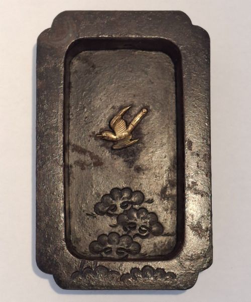 fig 1. A rectangular dark bronze recessed Japanese hikite door pull decorated with a gilt bird in flight and carved pine tree motifs.