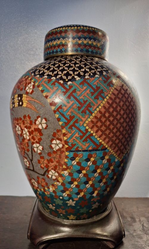 fig 1. A nineteenth-century Japanese cloisonne enamel ginger jar featuring a patterned mosaic design and a colourful bird among floral motifs.