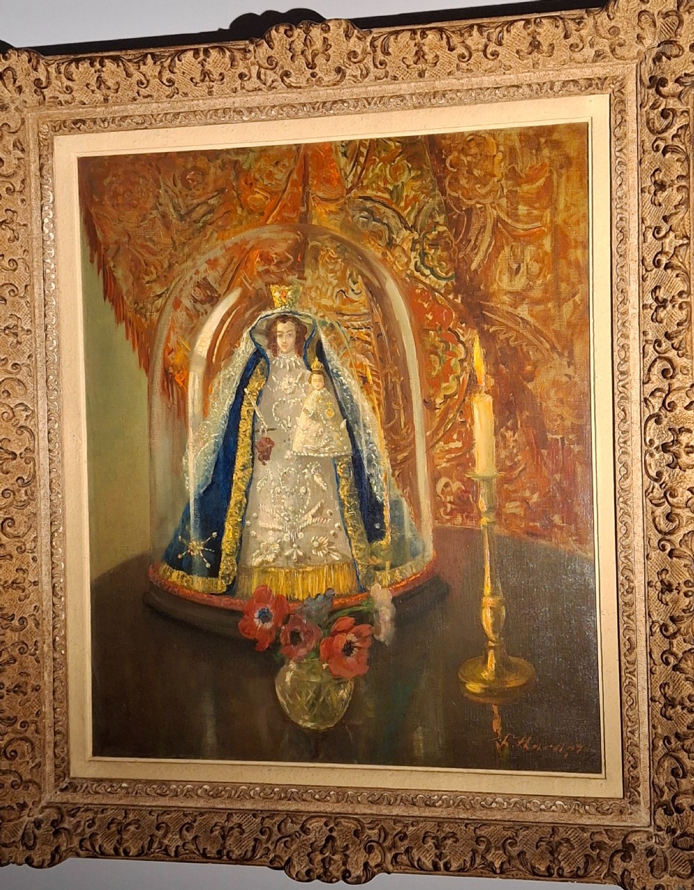 A framed 19th-century oil painting depicting a statue of the Madonna and Child beneath a glass cloche, flanked by a candle and a small vase of flowers. View VI