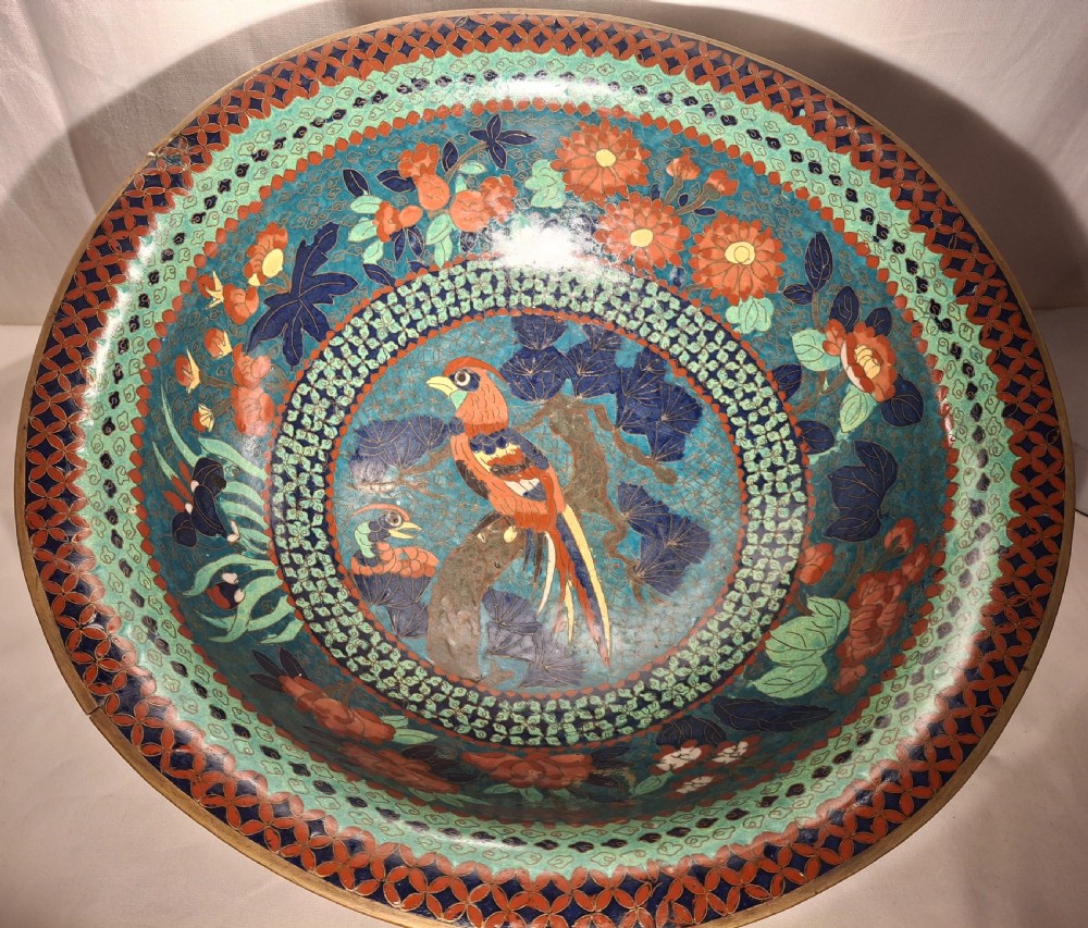 A broad Meiji period Japanese cloisonne enamel bowl featuring red peony blossoms and bird motifs on a turquoise patterned ground. View IV