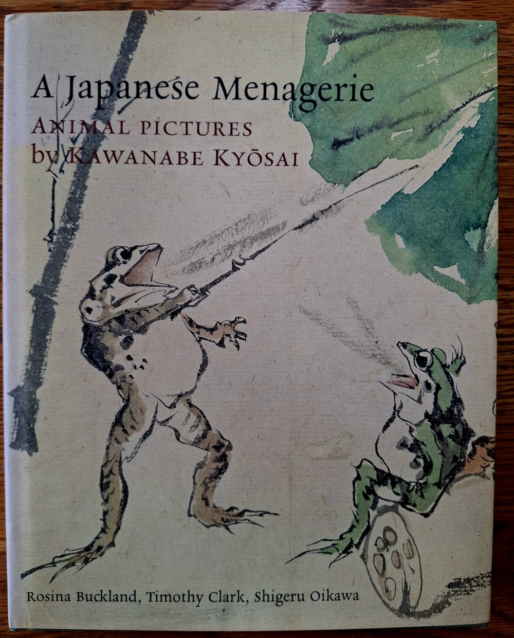 A framed pair of Japanese late nineteenth-century silk paintings depicting anthropomorphic frogs fighting with lotus flowers and reeds. View XI