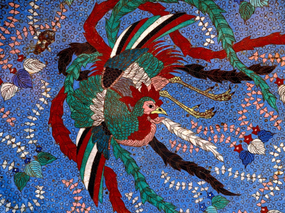 A large circular Japanese cloisonne charger featuring a colorful Ho-o phoenix bird amidst floral foliage against a cobalt blue background. View II