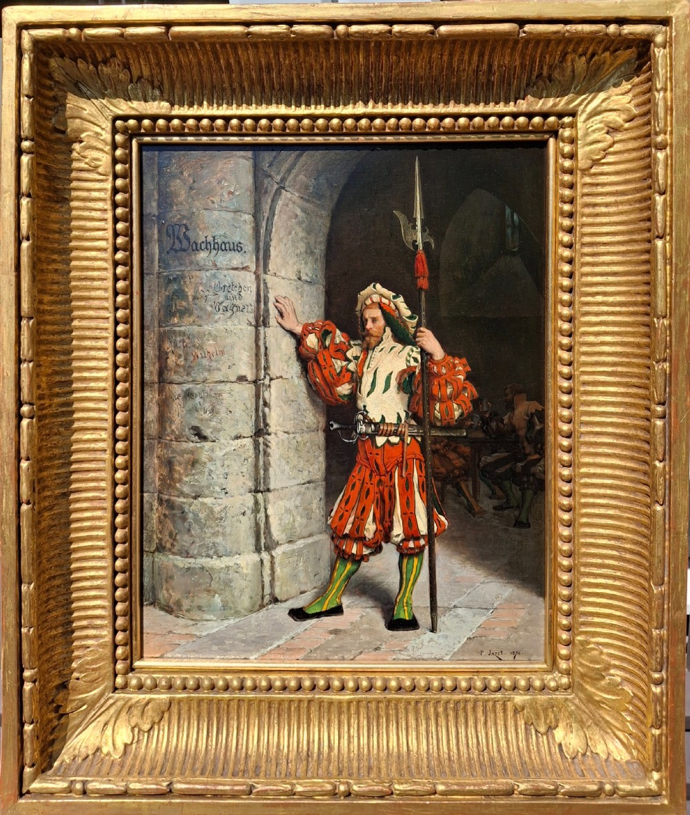 An 1874 oil painting on panel by Paul Leon Jazet in a heavy carved gilt frame, depicting a pikeman in historic costume standing beside a stone archway.
