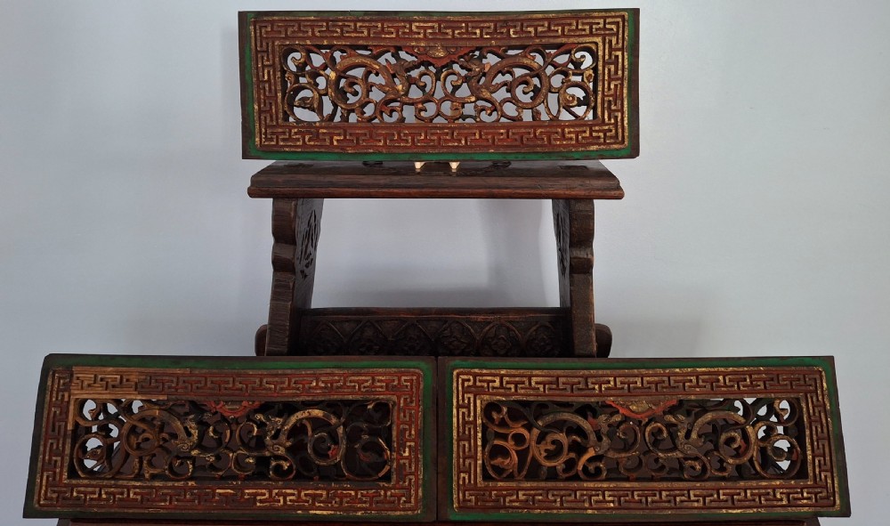 Set of twelve rectangular Chinese carved wooden panels featuring openwork scroll design, key fret borders, and worn red, green, and gold painted finishes. View VII