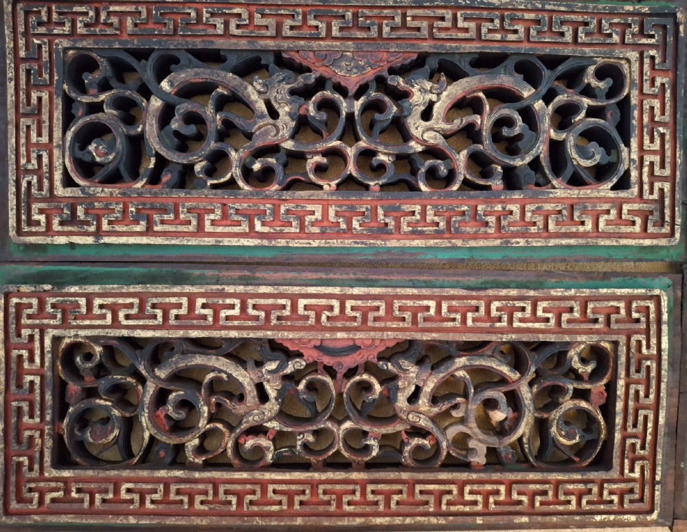 Set of twelve rectangular Chinese carved wooden panels featuring openwork scroll design, key fret borders, and worn red, green, and gold painted finishes. View VIII
