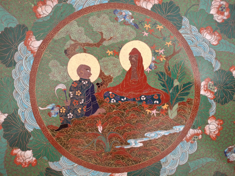 A circular Meiji period Japanese cloisonne enamel charger featuring central haloed figures surrounded by a lotus pattern on a green background. View II