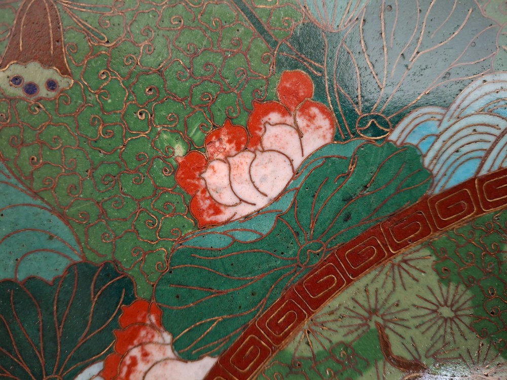 A circular Meiji period Japanese cloisonne enamel charger featuring central haloed figures surrounded by a lotus pattern on a green background. View VIII