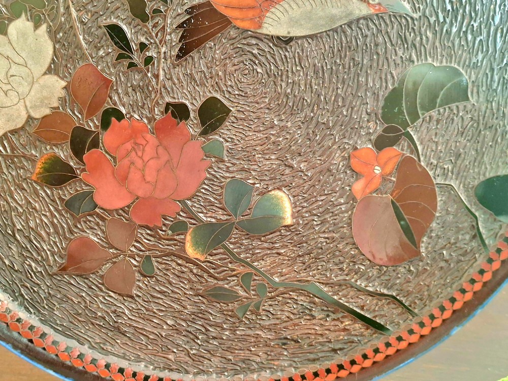 A pair of circular Japanese Totai Shippo porcelain plates depicting birds, lotus flowers, and peonies in polychrome enamel against a textured brown tree bark effect ground. View IV