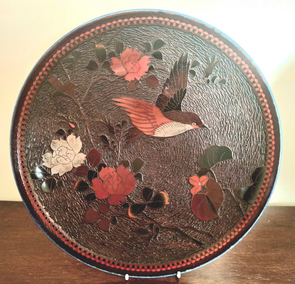 A pair of circular Japanese Totai Shippo porcelain plates depicting birds, lotus flowers, and peonies in polychrome enamel against a textured brown tree bark effect ground. View XII